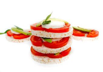 Healthy food - sandwiches, rice crackers with tomato, avocado and mozzarella cheese