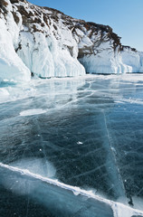 Winter landscape with ice on coastal rocks of Lake Baikal