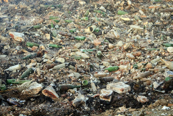 Large garbage dump waste with broken bottles
