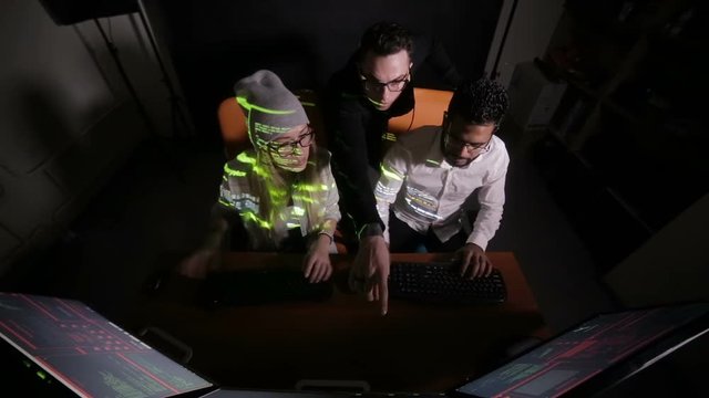Group of hacker using computer code in dark. HD.