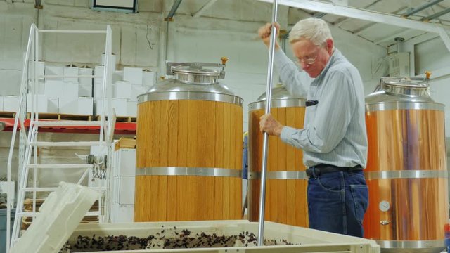 Work in the winery. Punch down cap