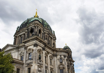 Fototapeta na wymiar Bottom view of Berliner Dom with cloudy sky background. Majestic