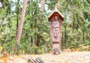 Old wooden sculptures in the forest. Witch Hill park, Lithuania.