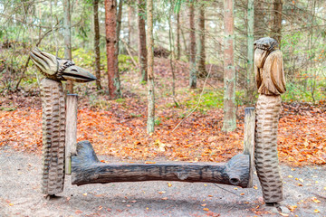Old wooden sculptures in the forest. Witch Hill park, Lithuania.