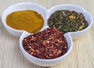 Assorted spices in white bowls