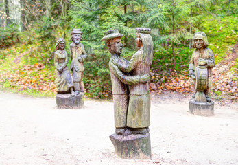 Old wooden sculptures in the forest. Witch Hill park, Lithuania.