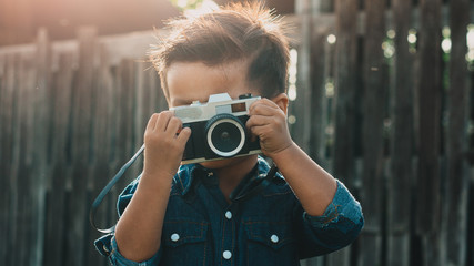 Little boy with a vintage camera