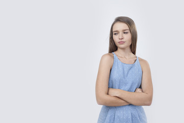 Displeased European woman in blue dress