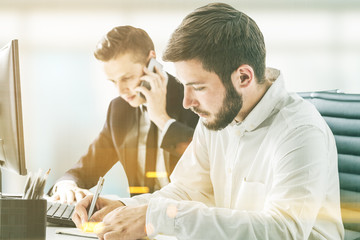 Two businessmen working at their workplace