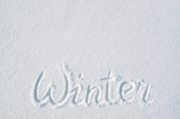 Winter calligraphy hand lettering handwritten on flat snowy surface. Nice holiday horizontal postcard, greeting card template. Empty space for copy, text.