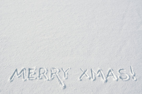 Merry Xmas letters handdrawn on flat snow surface. Nice horizontal holiday postcard, greeting card template. Empty space for copy, text, lettering.