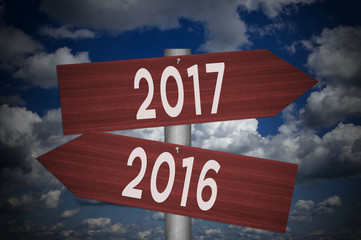 New year 2017 road sign with cloudy sky background.
