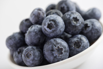 Group of fresh juicy blueberries on white background