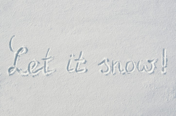 Beautiful let it snow letters calligraphy handdrawn on flat snow surface. Nice Christmas holiday square postcard, greeting card.