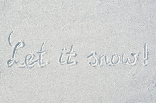 Beautiful let it snow letters calligraphy handdrawn on flat snow surface. Nice Christmas holiday square postcard, greeting card.