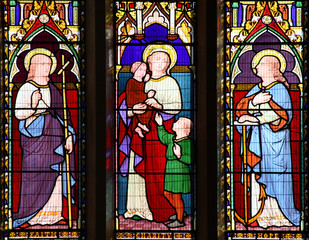 Fototapeta premium Faith Hope Charity stained glass window at St Peter's Church in the city centre of Carmarthen
