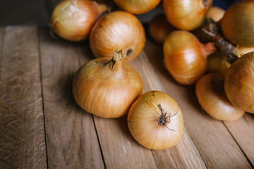 beautiful ripe yellow onions on a wooden background