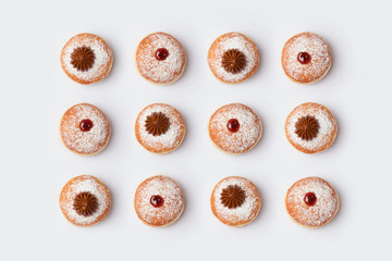 Jewish holiday Hanukkah donut sufganiyot on white background. View from above. Flat lay