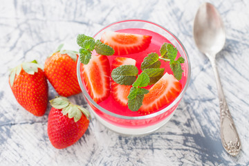 cottage cheese and berry jelly in a glass on a table, selective focus