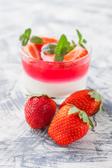 cottage cheese and berry jelly in a glass on a table, selective focus