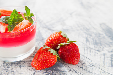 cottage cheese and berry jelly in a glass on a table, selective focus