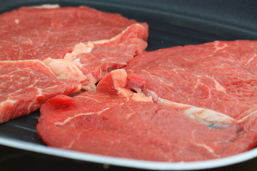 Beef steaks in a griddle pan