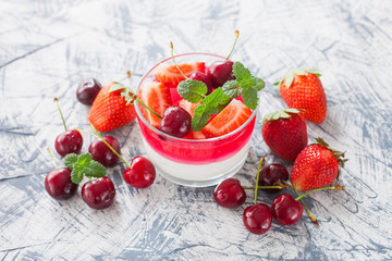 cottage cheese and berry jelly in a glass on a table, selective focus