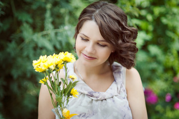 Closeup portrait of young woman with yellow flowers.