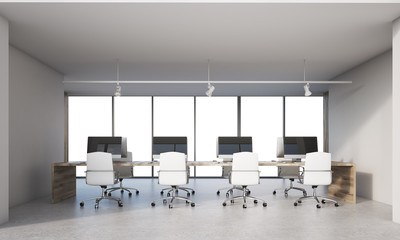 Four computers on desk in office