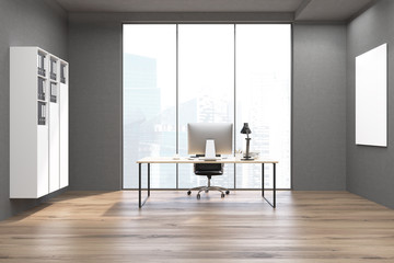 CEO office with bookshelves, computer and poster