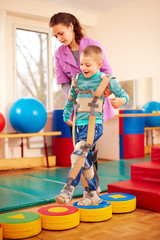 cute kid having physical musculoskeletal therapy in rehabilitation center © Olesia Bilkei