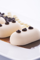 Creamy ice cream with chocolate on a white plate