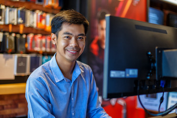 Handsome young asian man using computer in office