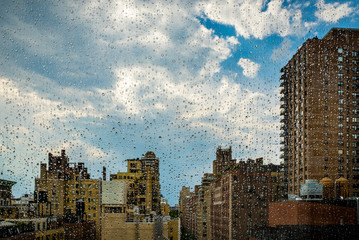 View of New York cityscape through a rainy window.