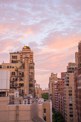 Fototapeta premium Balcony view of a New York City neighborhood with a colorful morning sky.