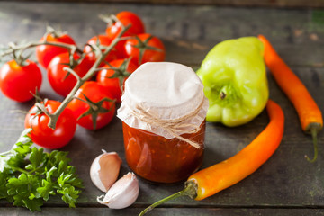 tomato sauce adjika and vegetables on a table, selective focus