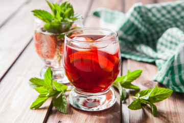 drinks with strawberry and orange in a glass on a table, selective focus