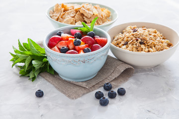 muesli with berries in a bowl on a table, selective focus
