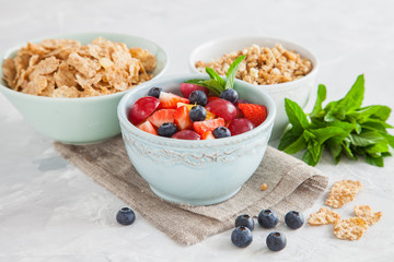 muesli with berries in a bowl on a table, selective focus