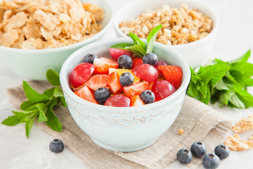 muesli with berries in a bowl on a table, selective focus
