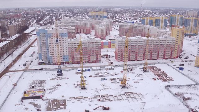 Aerial video footage of a construction crane at a construction site
