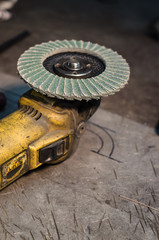 Angle grinder with rotary blade on an aluminum surface