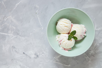 ice cream with strawberry sauce in a bowl on a table, selective focus