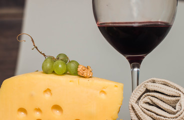 cheese plate for wine includes cheese, grapes , honey and nuts