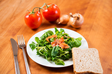 field salad with carrot, tomato, onion and bread