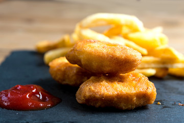 Chicken nuggets with sauce and golden French fries potatoe