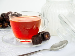 Dried dates and  cup of black tea. Isolated on white background