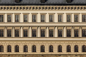 Fototapeta na wymiar Close up of historic building. Many windows in a row.