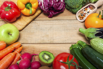 Colorful fruits and vegetables on wood background 