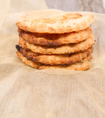 Cookies on a gold cloth on wooden background